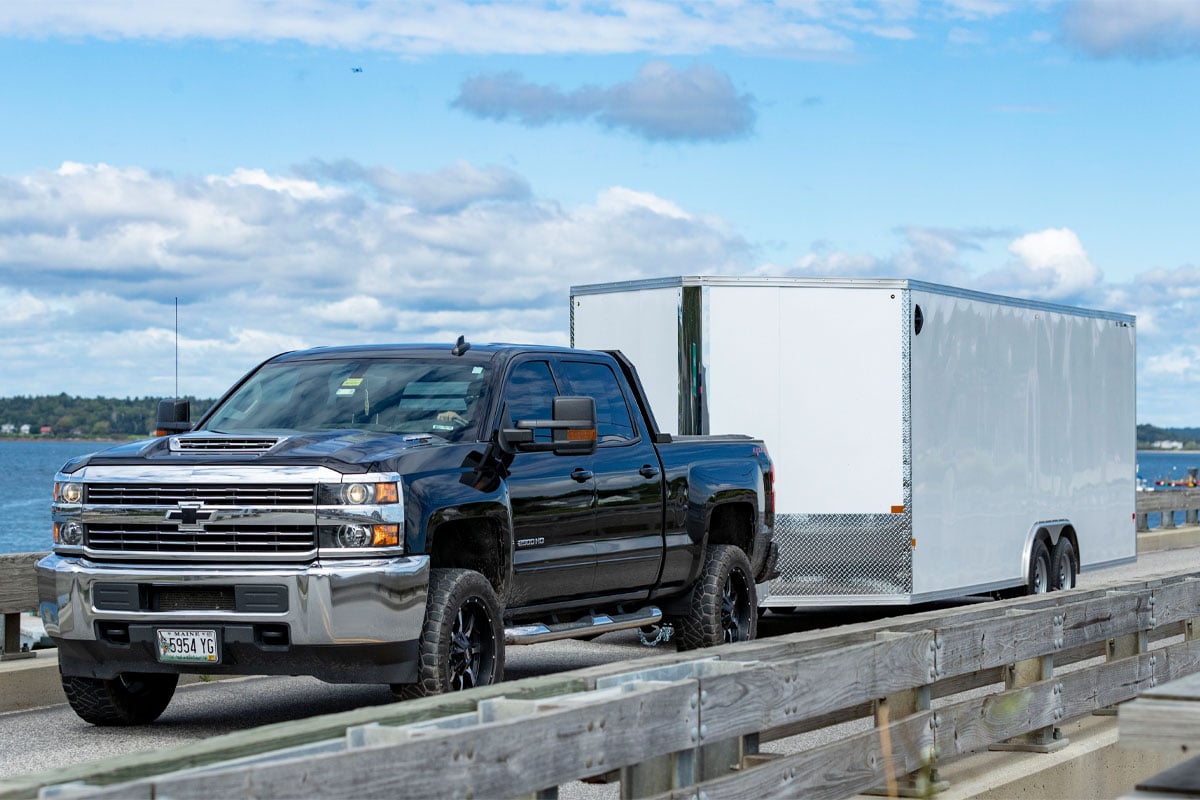 Black Truck Hauling Enclosed 8.5 Wide Cargo Trailer Near Seaside