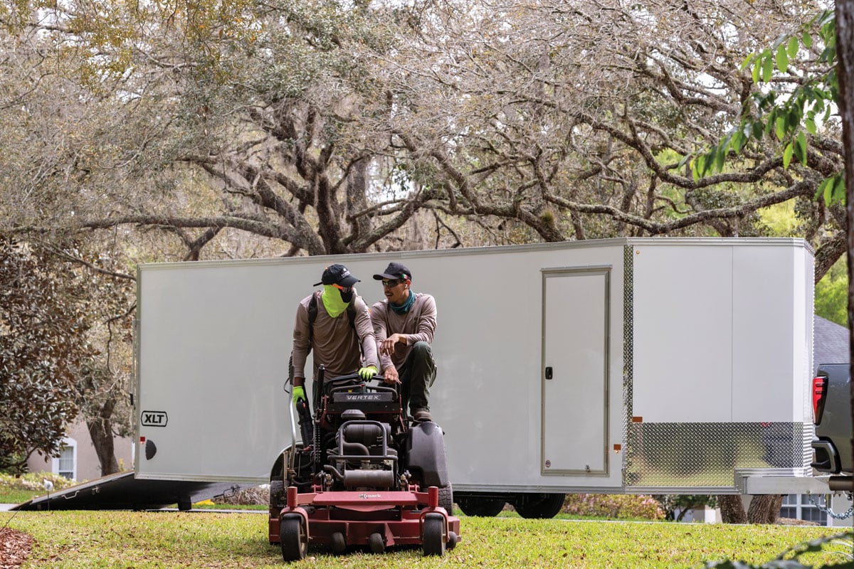 Landscapers in front of white XLT Pro Car Hauler