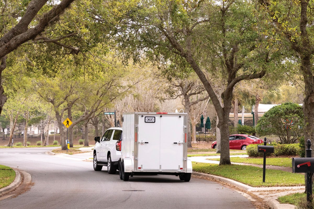 Rear View of white 7 wide XLT pro driving down road