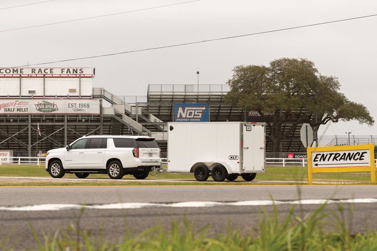 White XLT 7 Wide Pro parked in front of race track